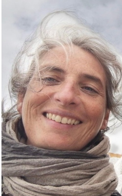 Woman's face smiling with sky in background